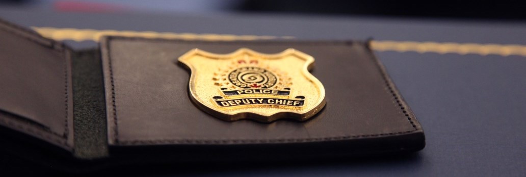 close up of Deputy Chief police badge on table