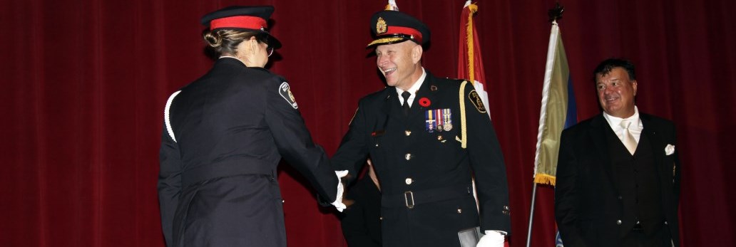 Chief smiling and shaking hand of new Officer recruit