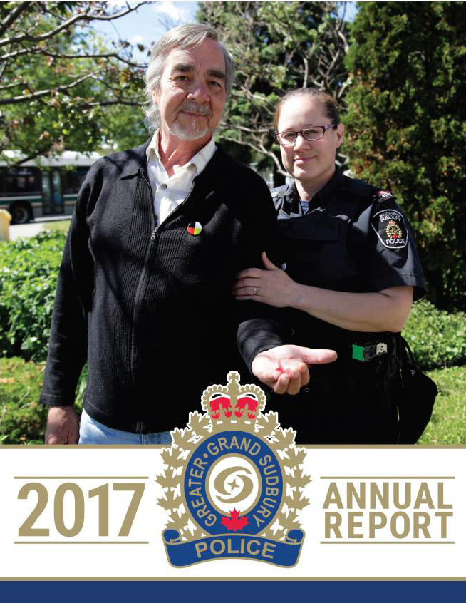 Woman officer and man standing together holding strawberries