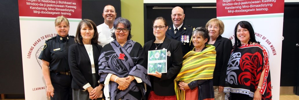 group of people holding a document