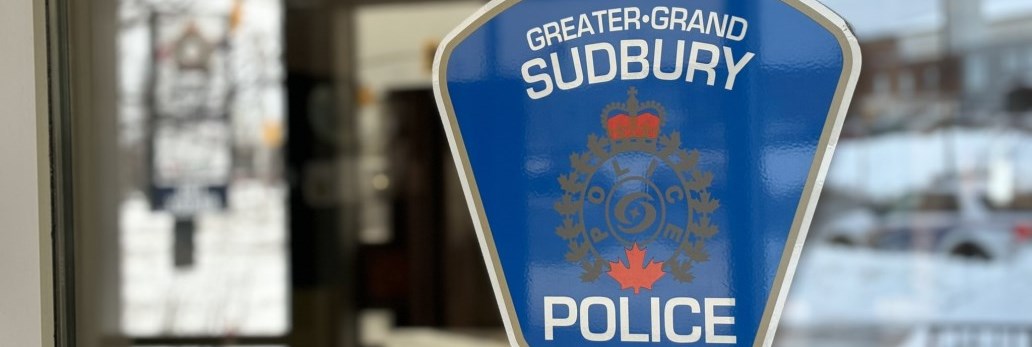 police service crest sticker on exterior window