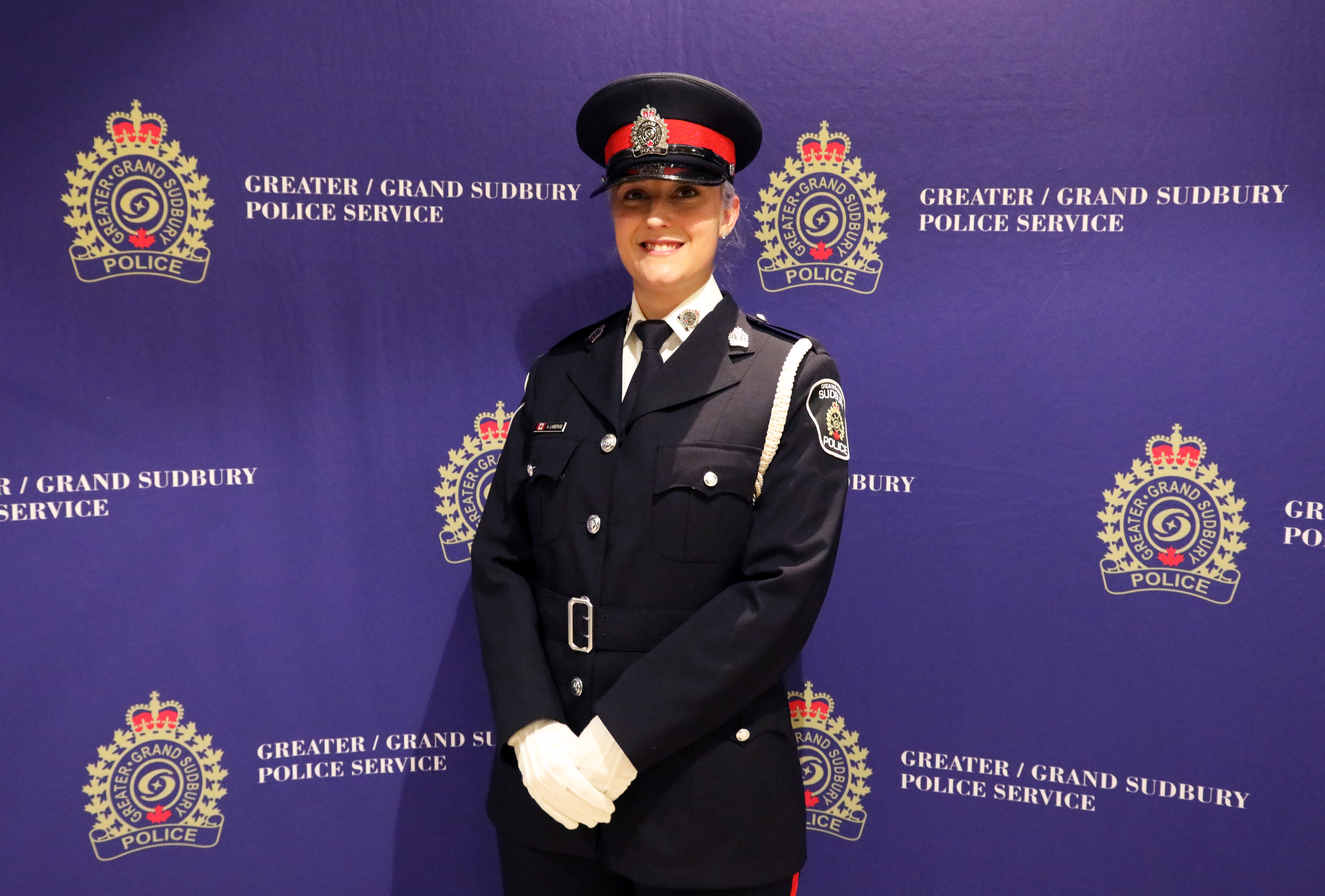 officer in uniform standing and smiling