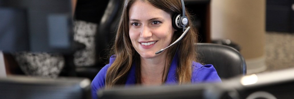 Communicator smiling while looking at computer screen