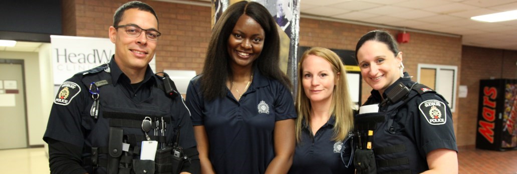 Officers and Civilians standing together smiling