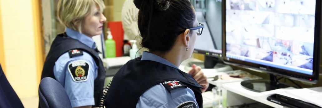 court security officers monitoring security camera footage