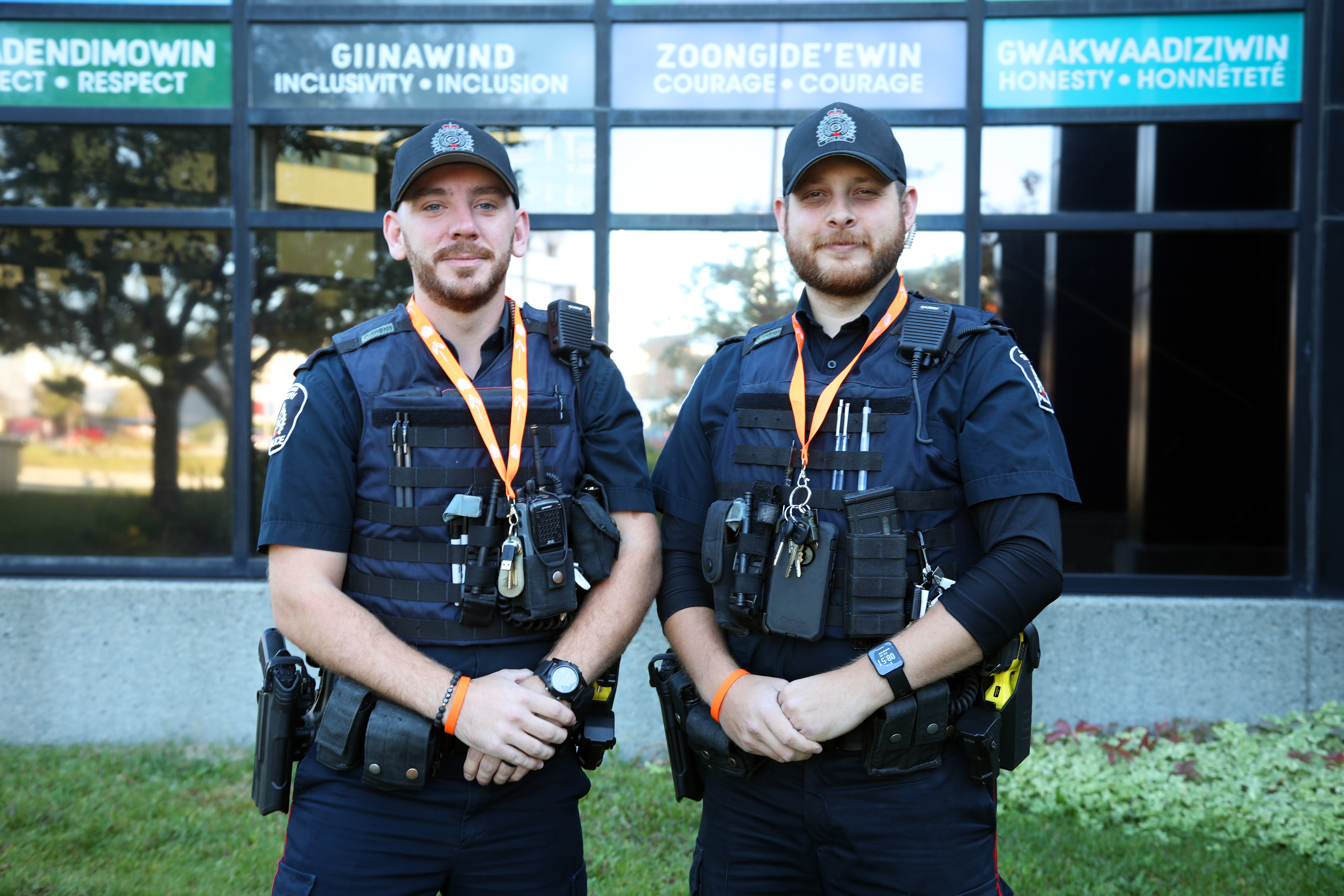 two officers in uniform wearing orange lanyards