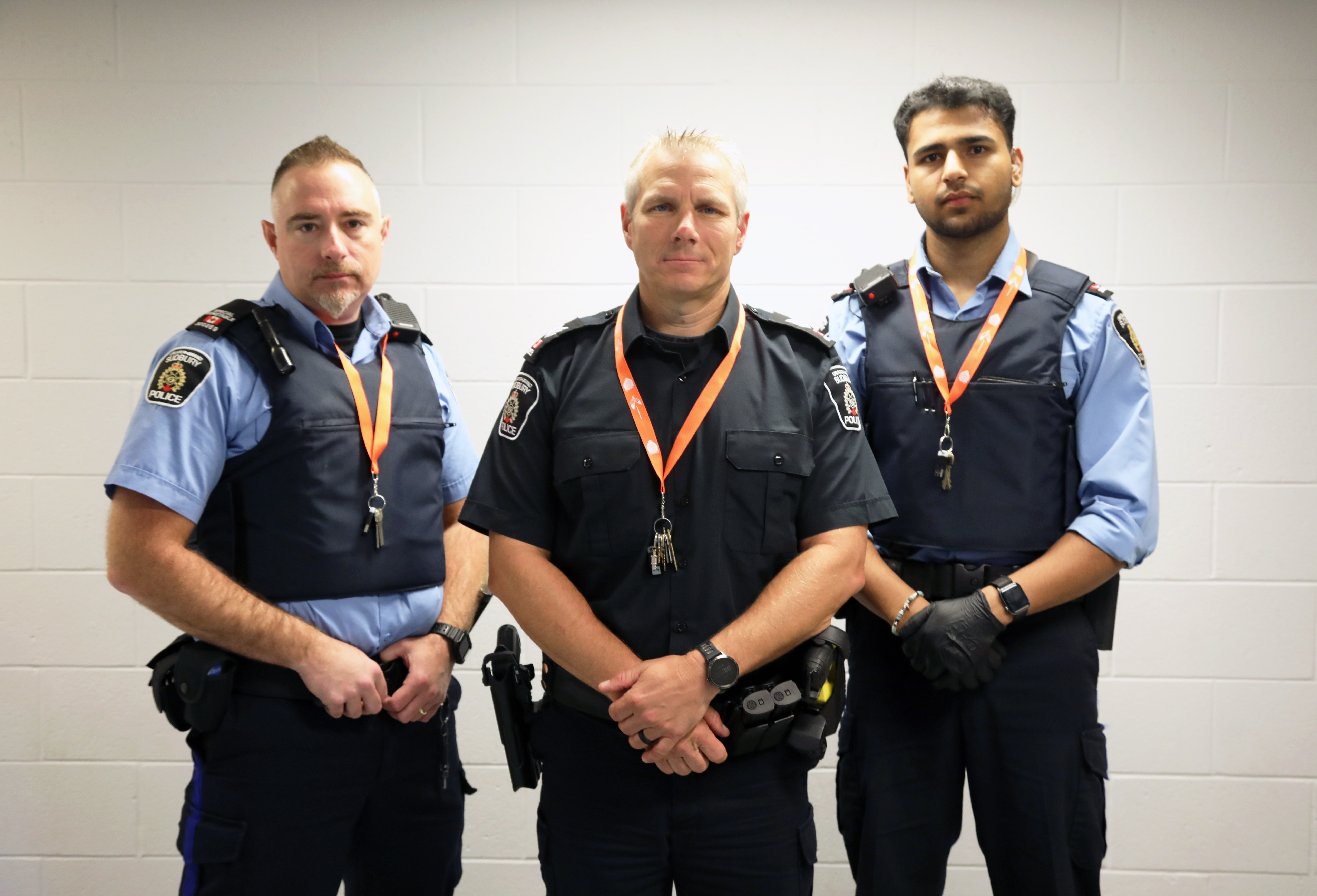 group of police officers wearing orange lanyards