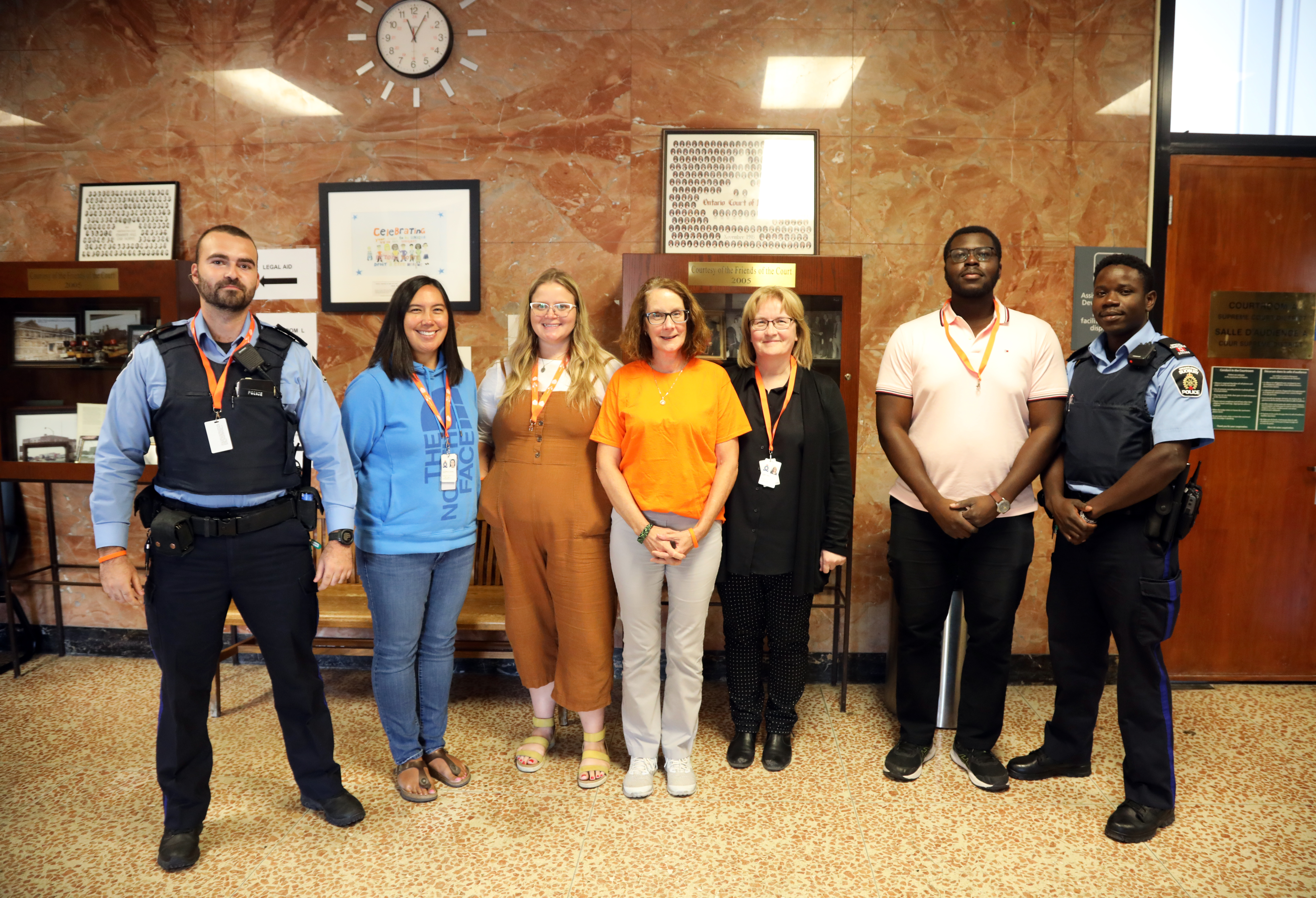 group of people wearing orange inside courthouse