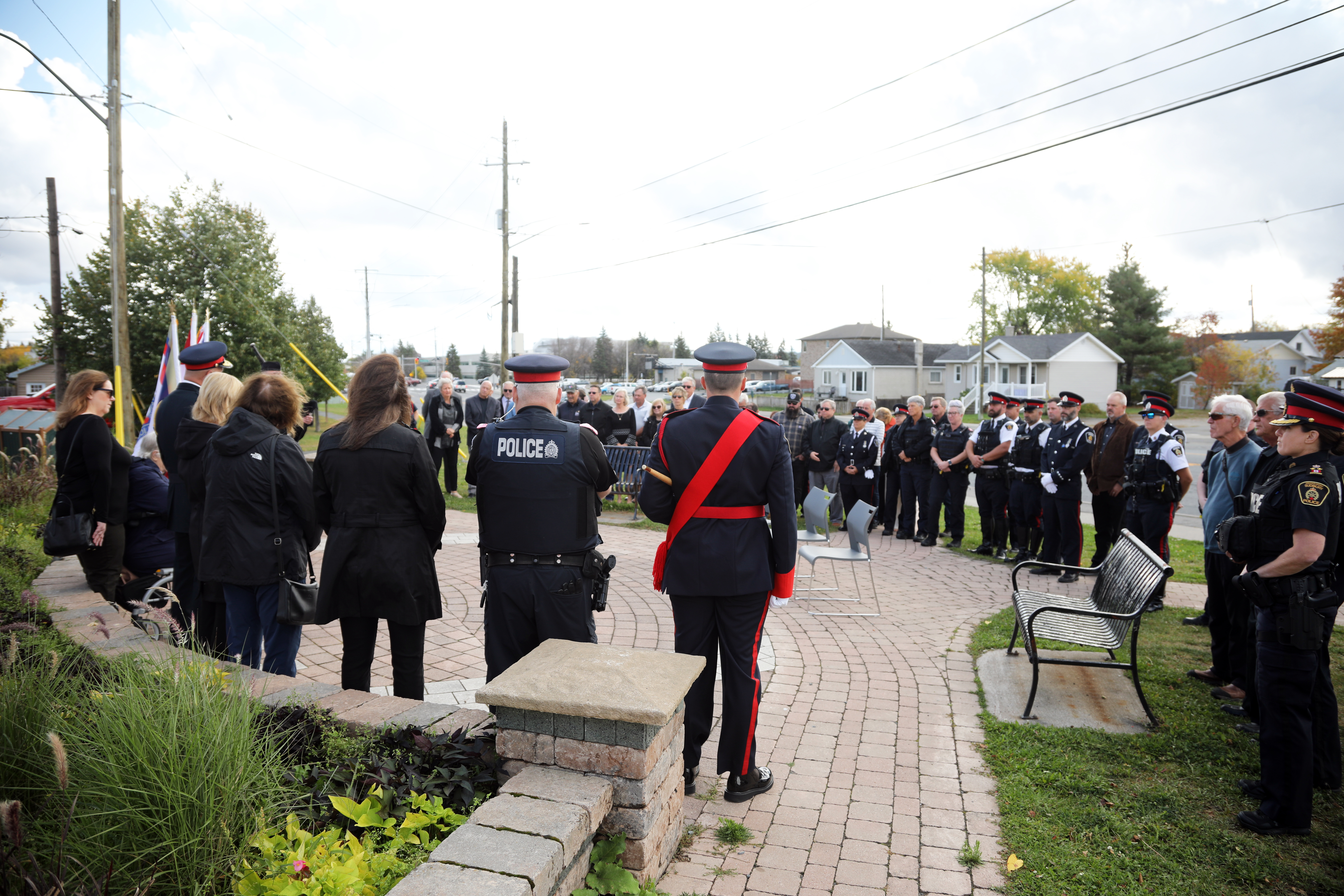 group of people standing outside for a memorial service