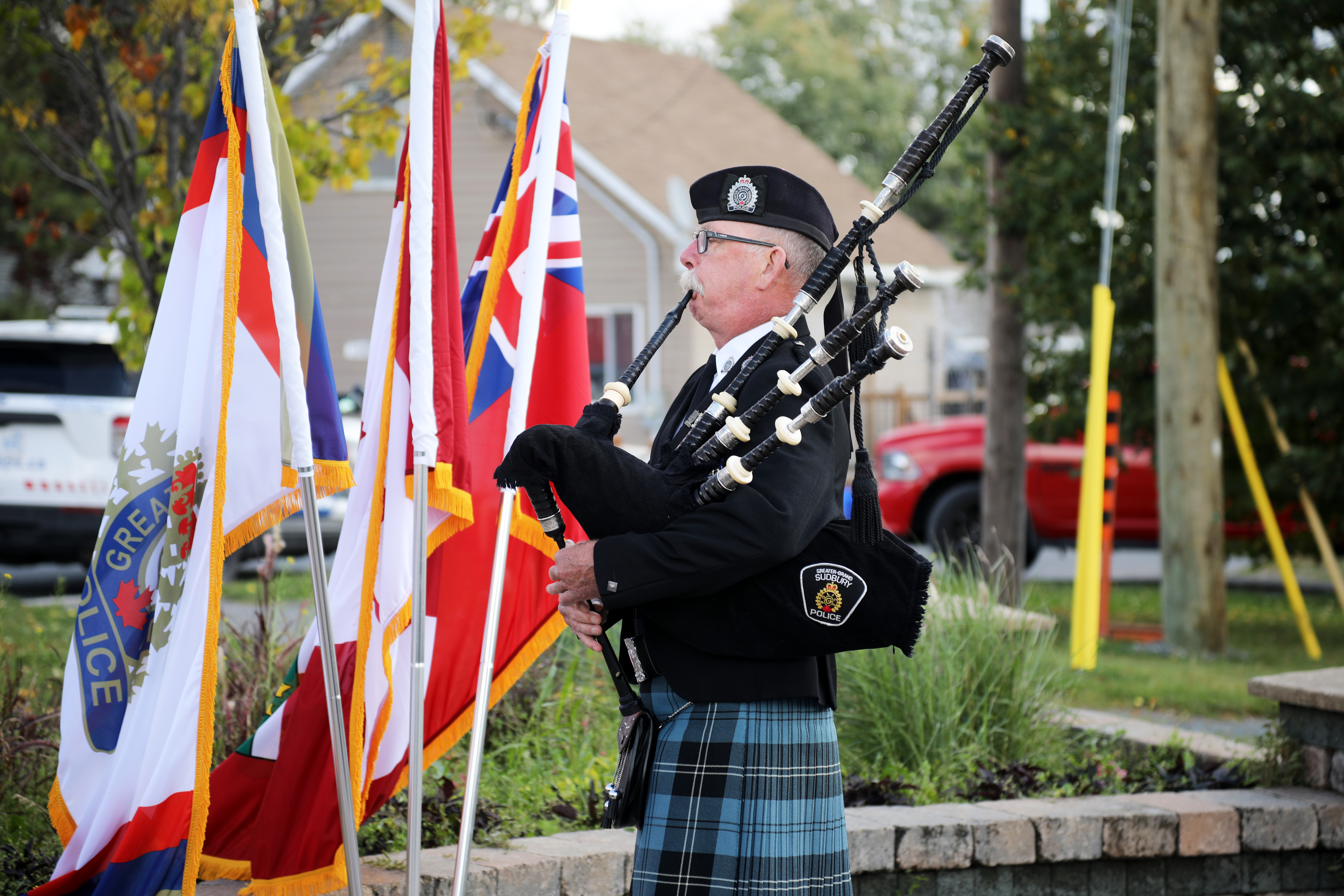 Remembering Cst. Joseph MacDonald piper standing outside