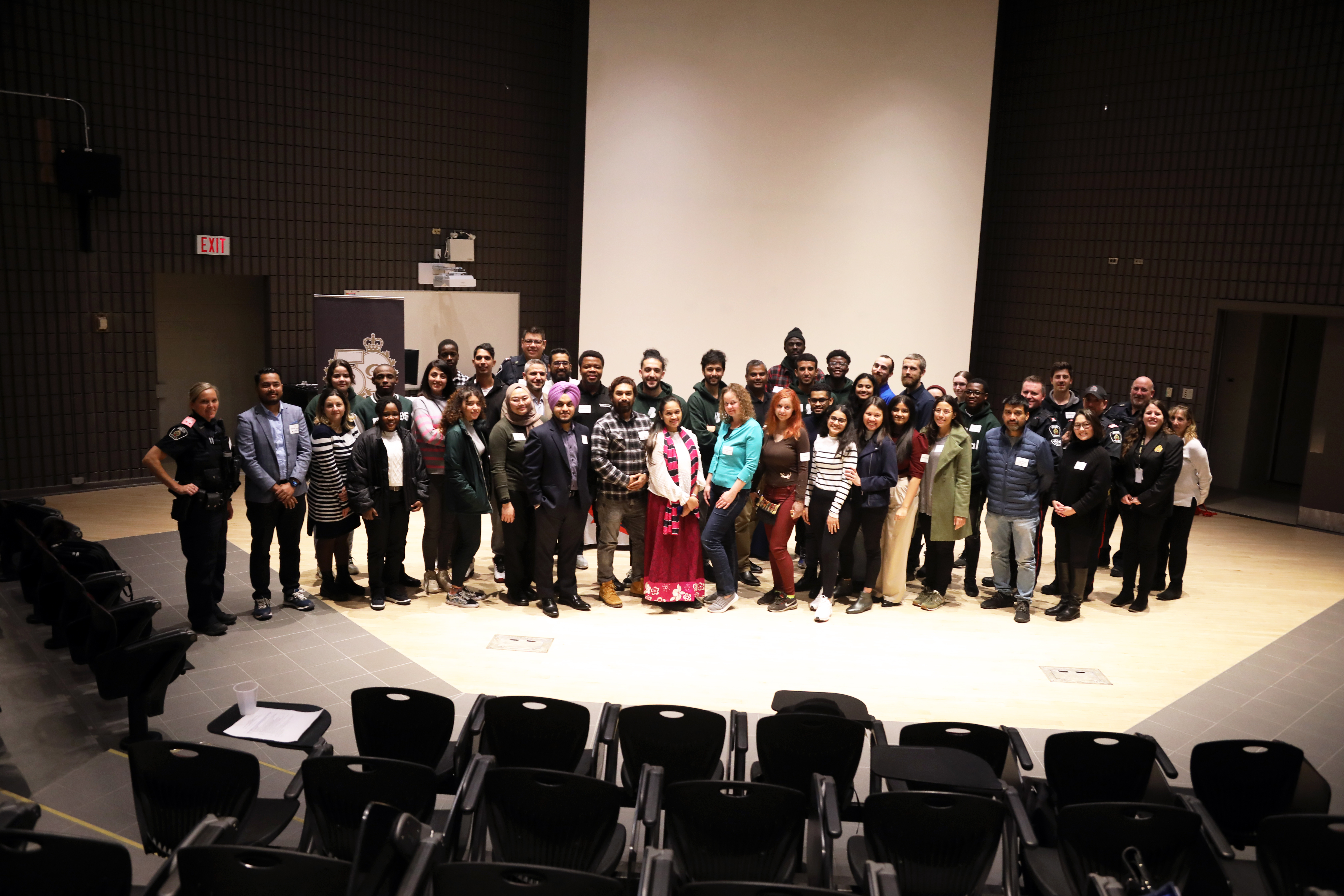 group of people standing in auditorium