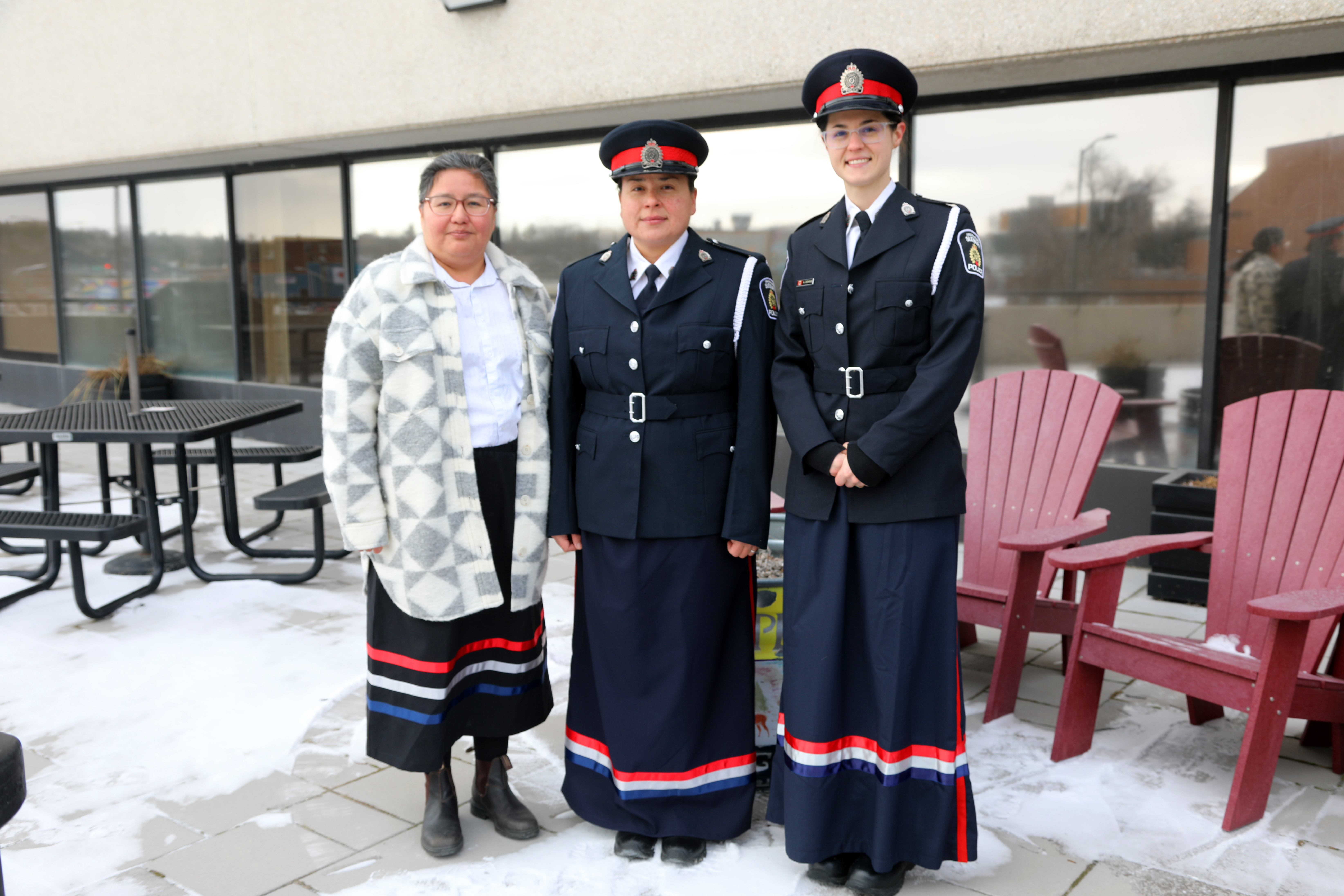 three women wearing ribbon skirts