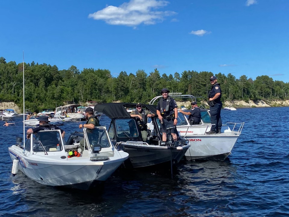 Police officers in boats on the lake