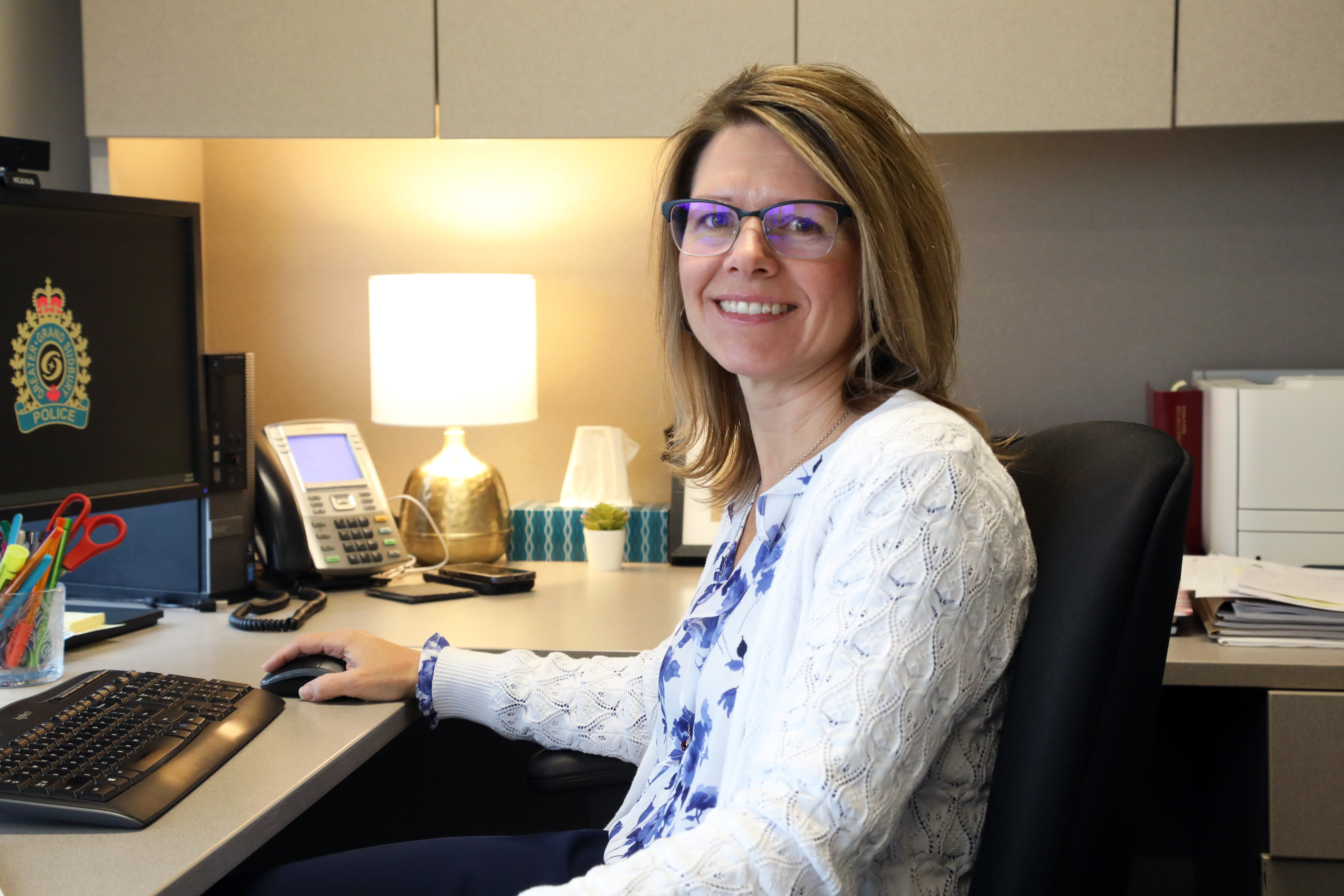 woman smiling sitting at desk