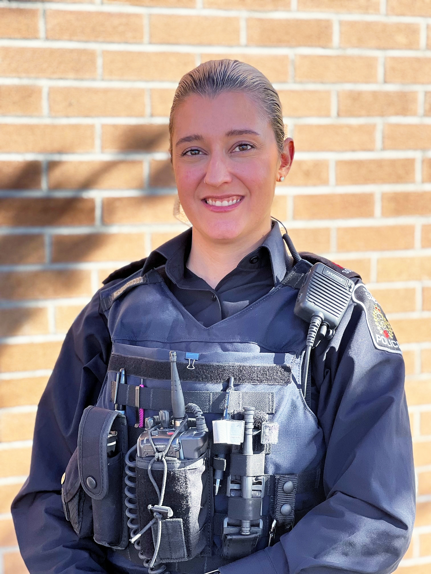 female police officer in uniform smiling