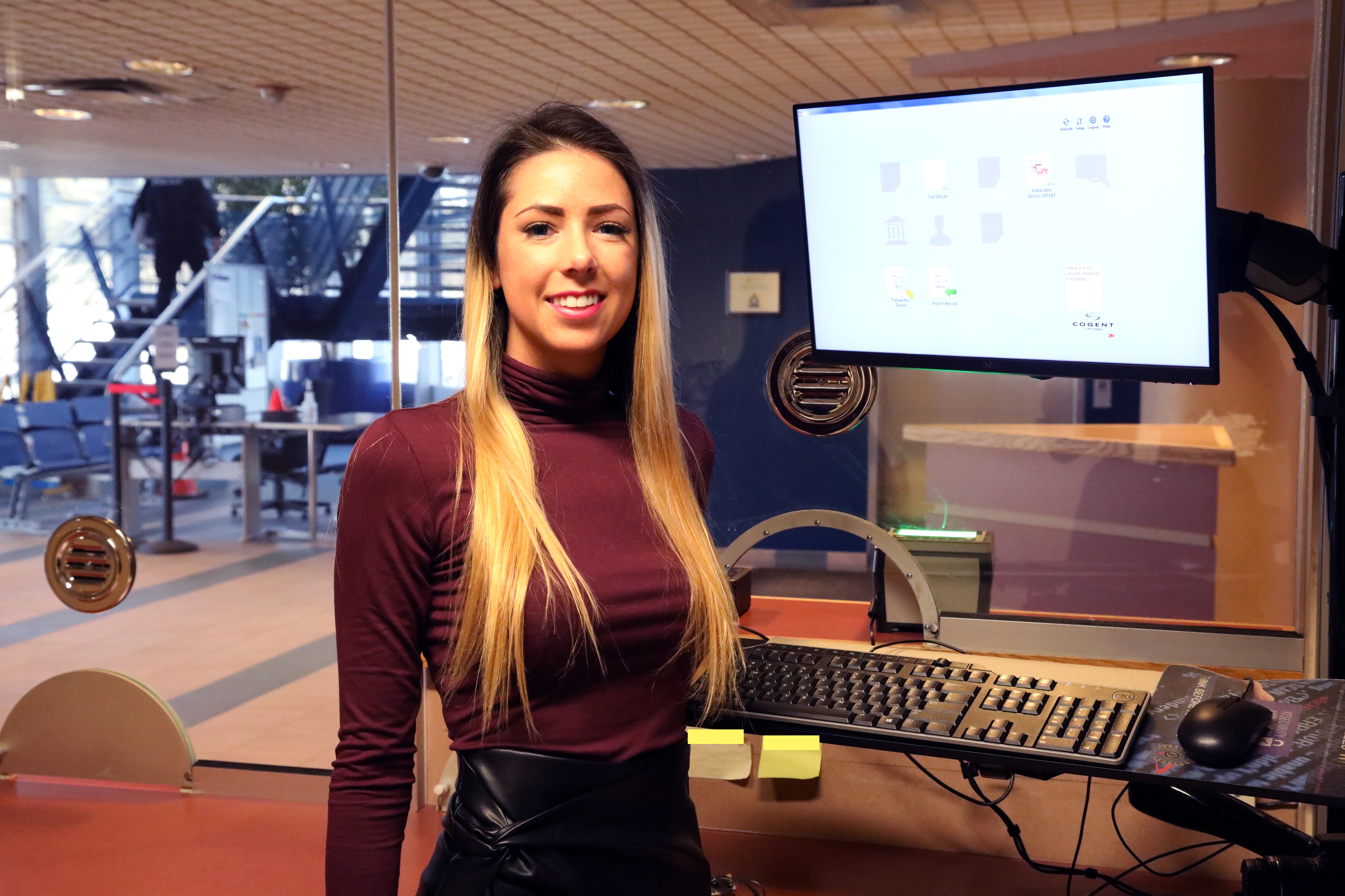 woman standing beside computer monitor