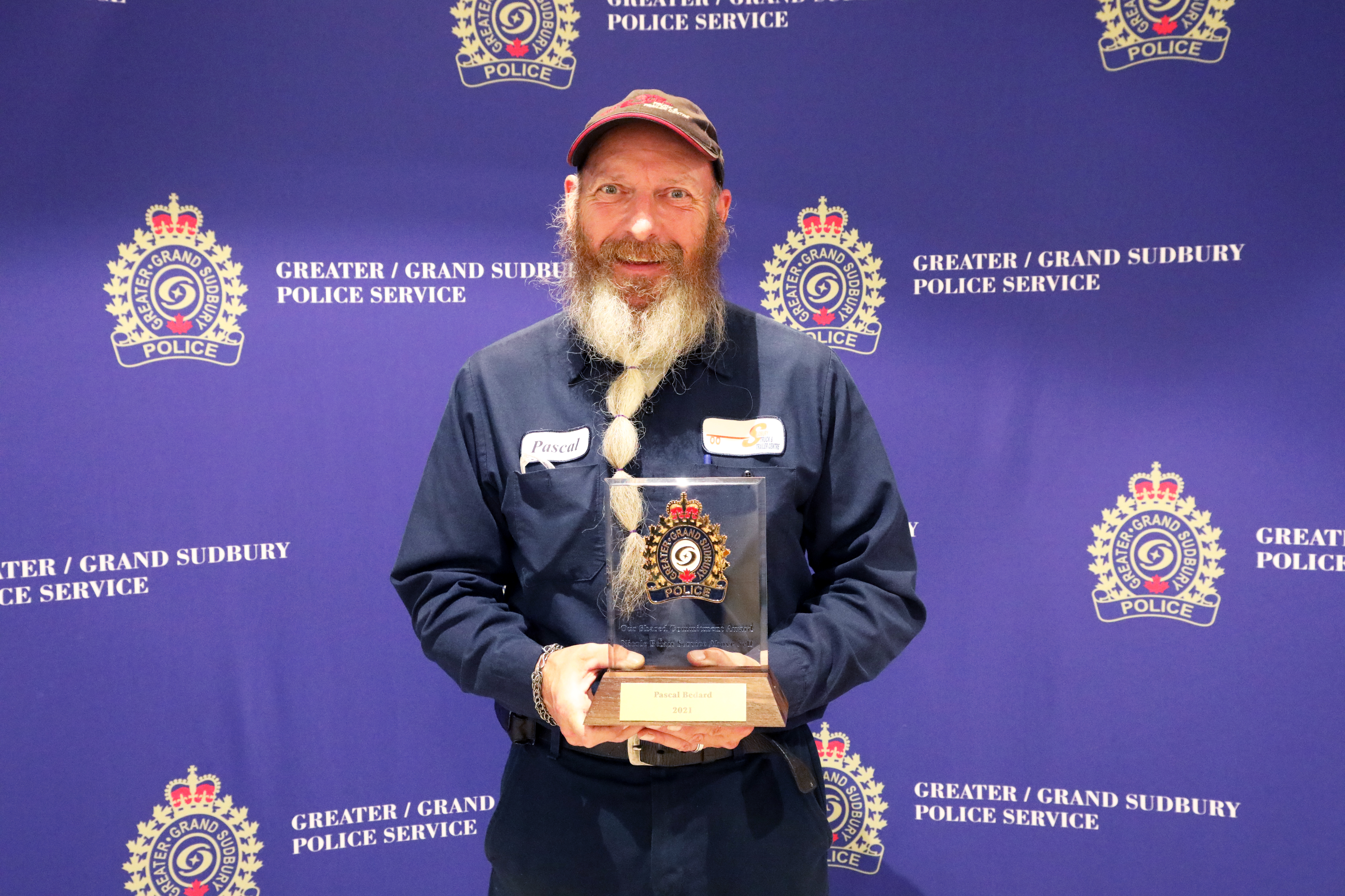 Man smiling and holding award