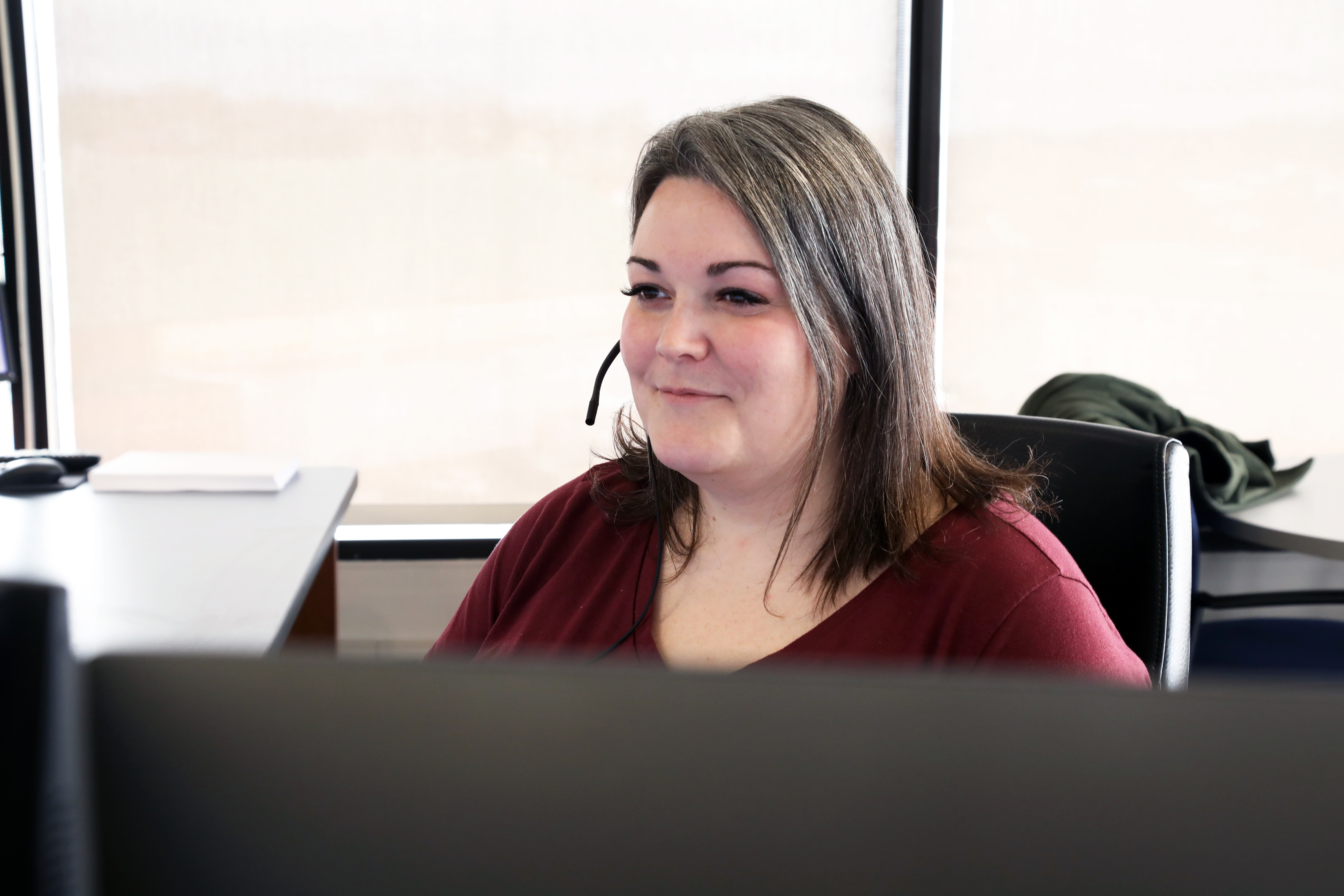 woman sitting at desk looking at monitor
