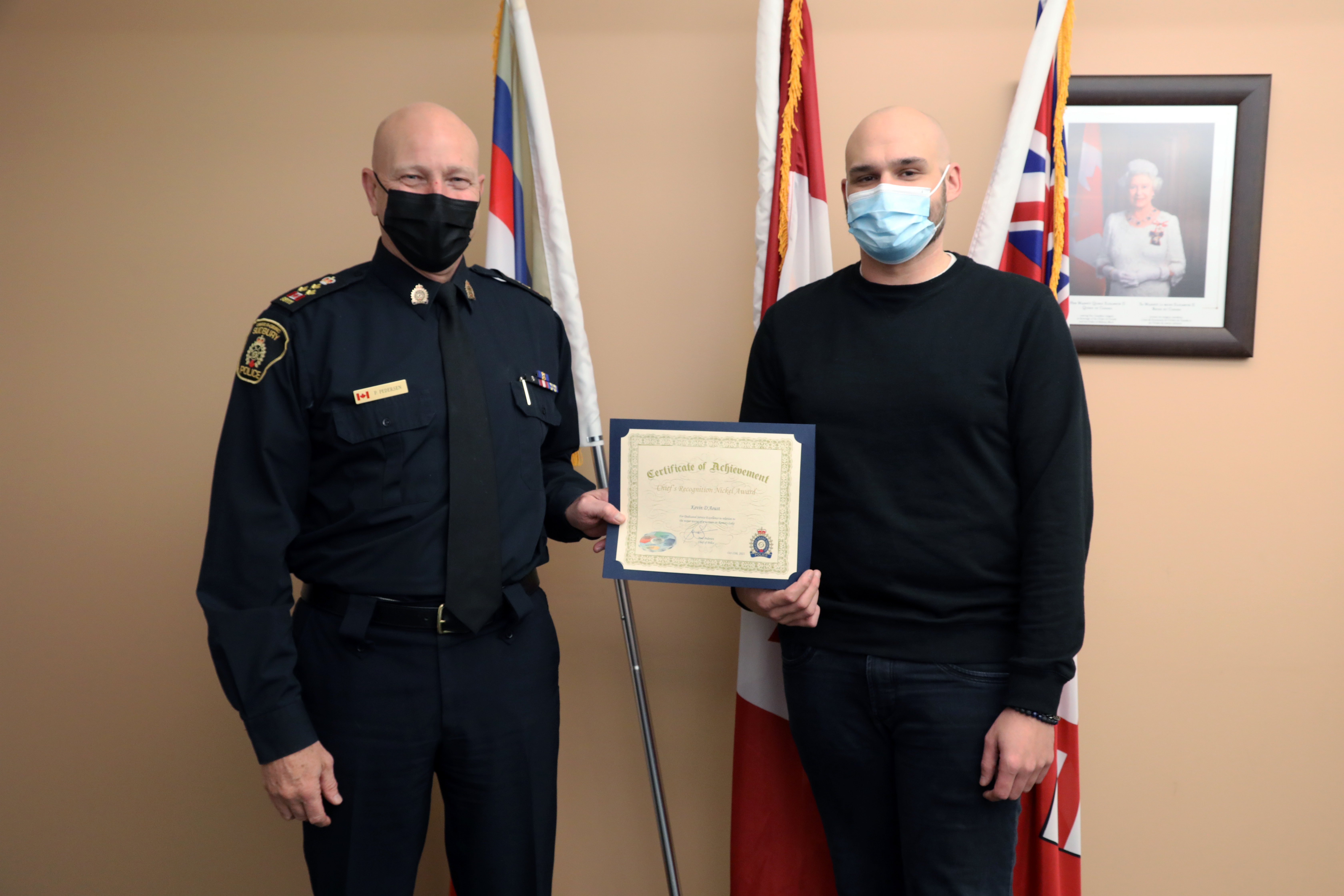 Chief of police and man standing holding certificate