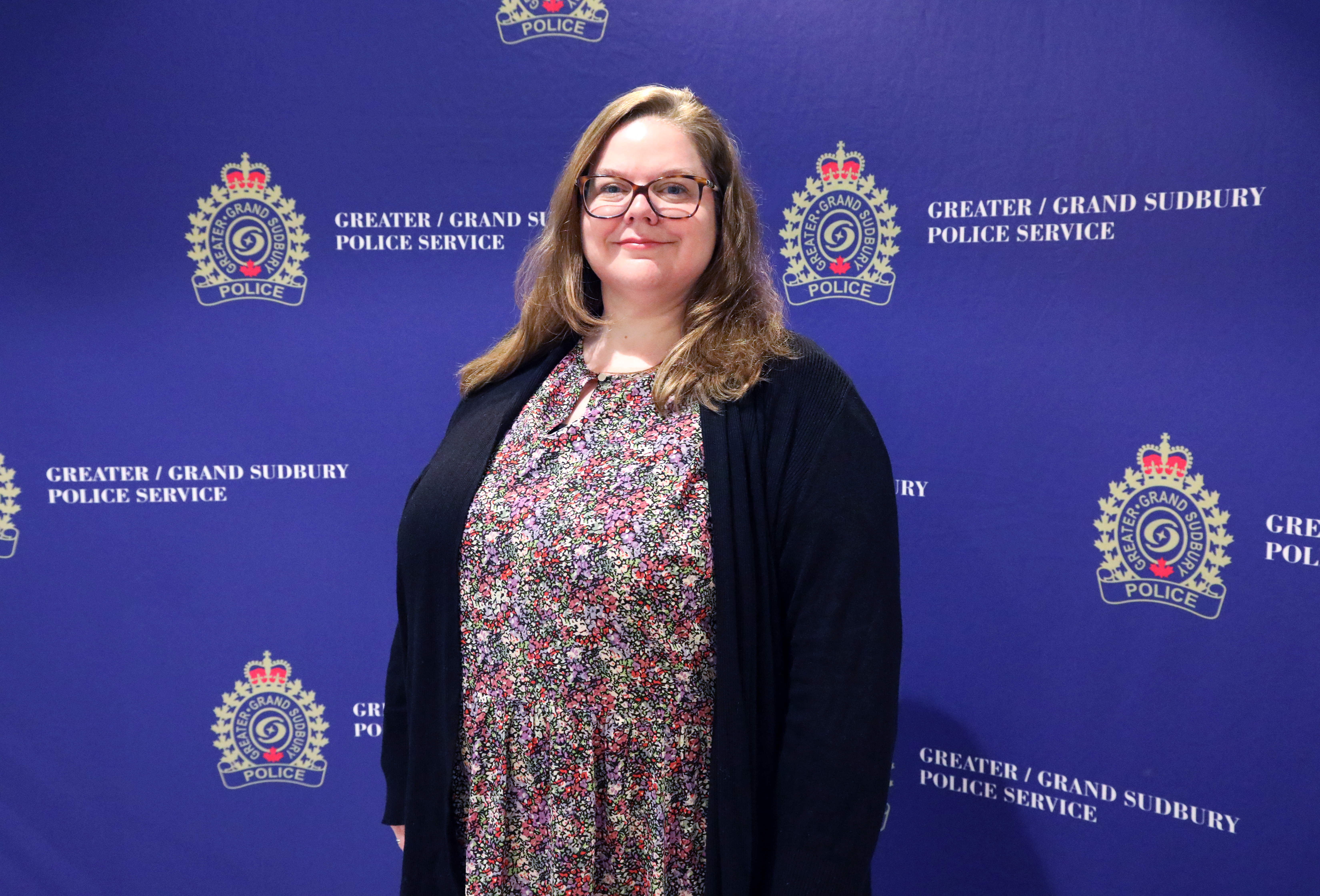 woman standing in front of media wall