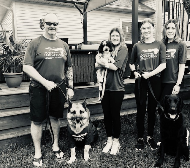 people standing smiling with dog