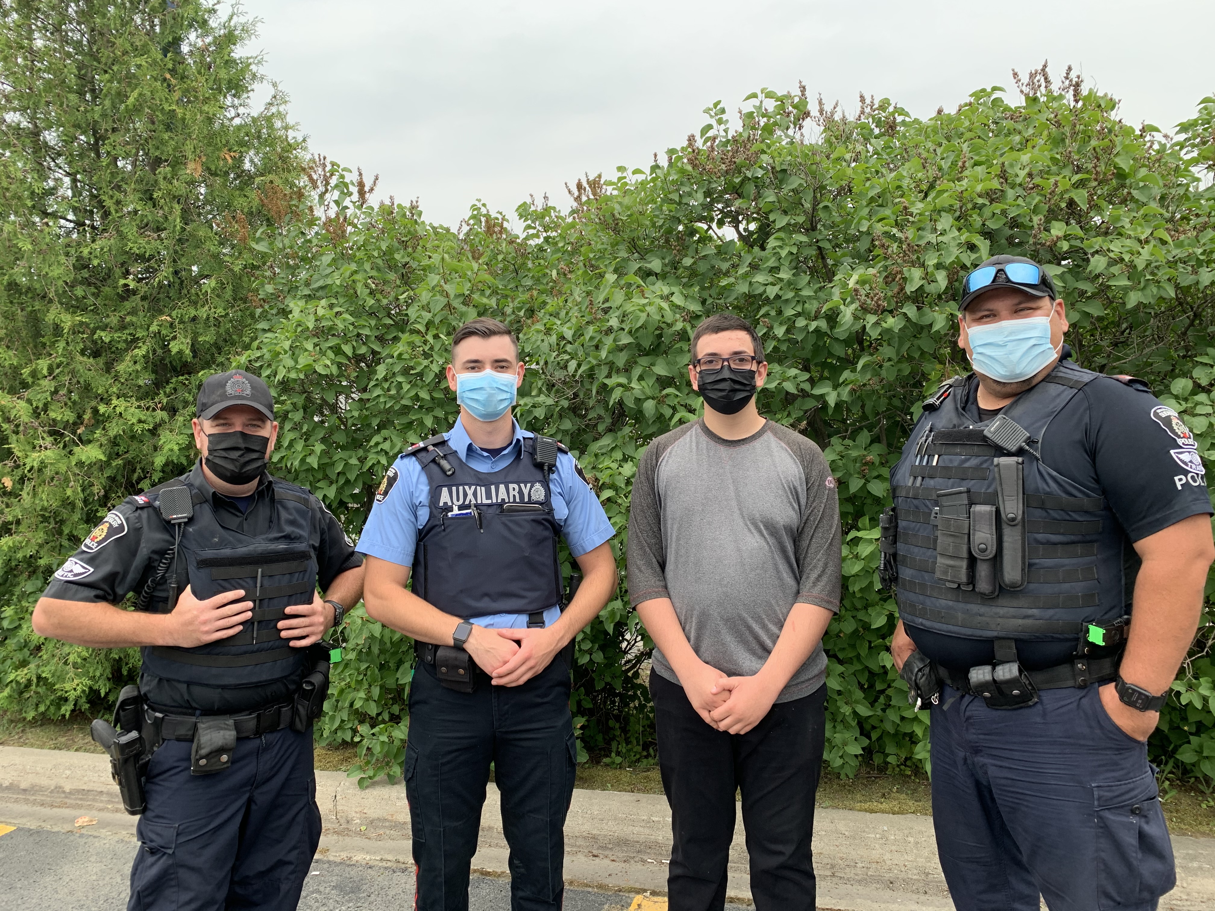 Four men standing wearing masks