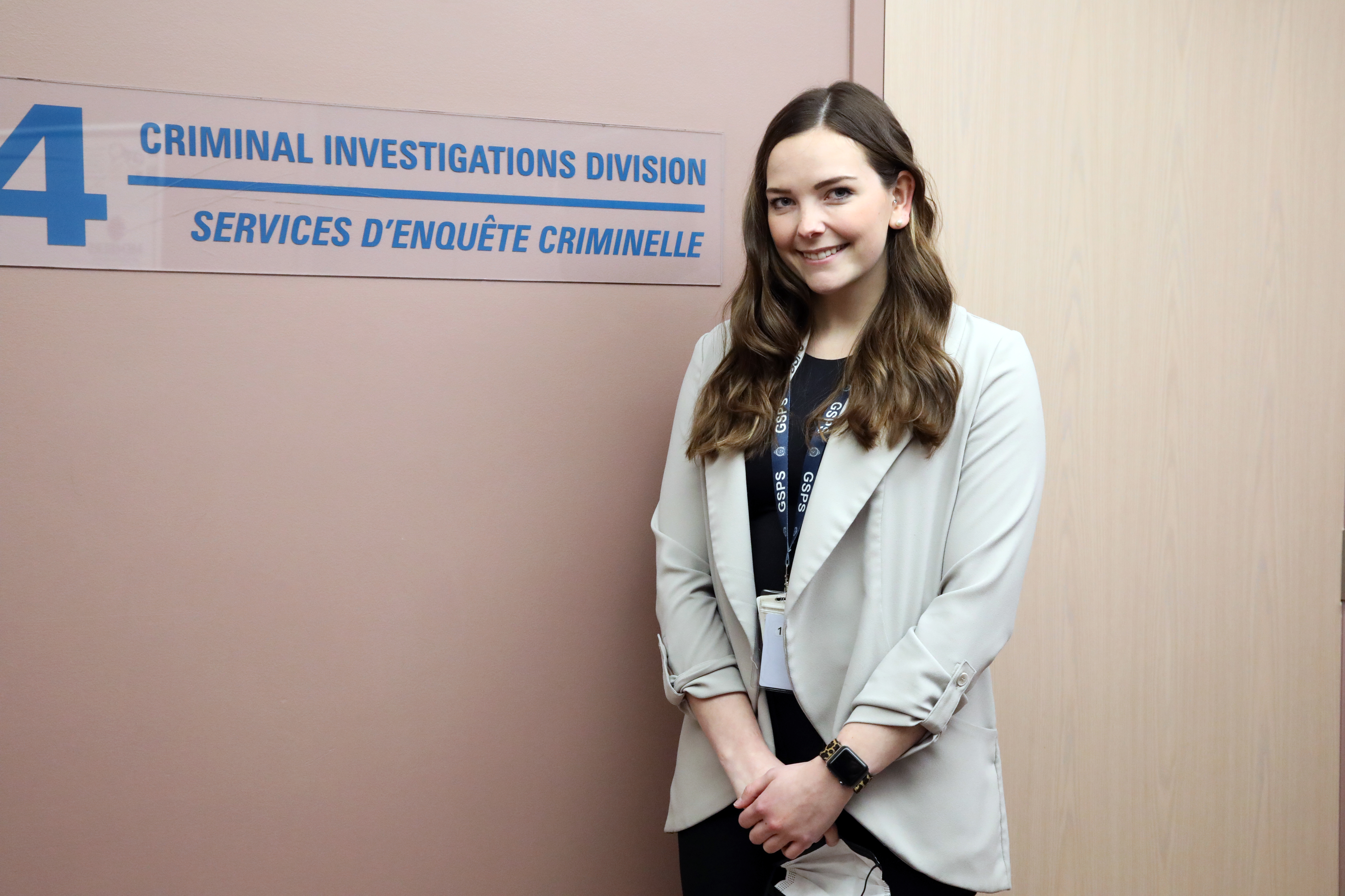 woman standing and smiling in police building