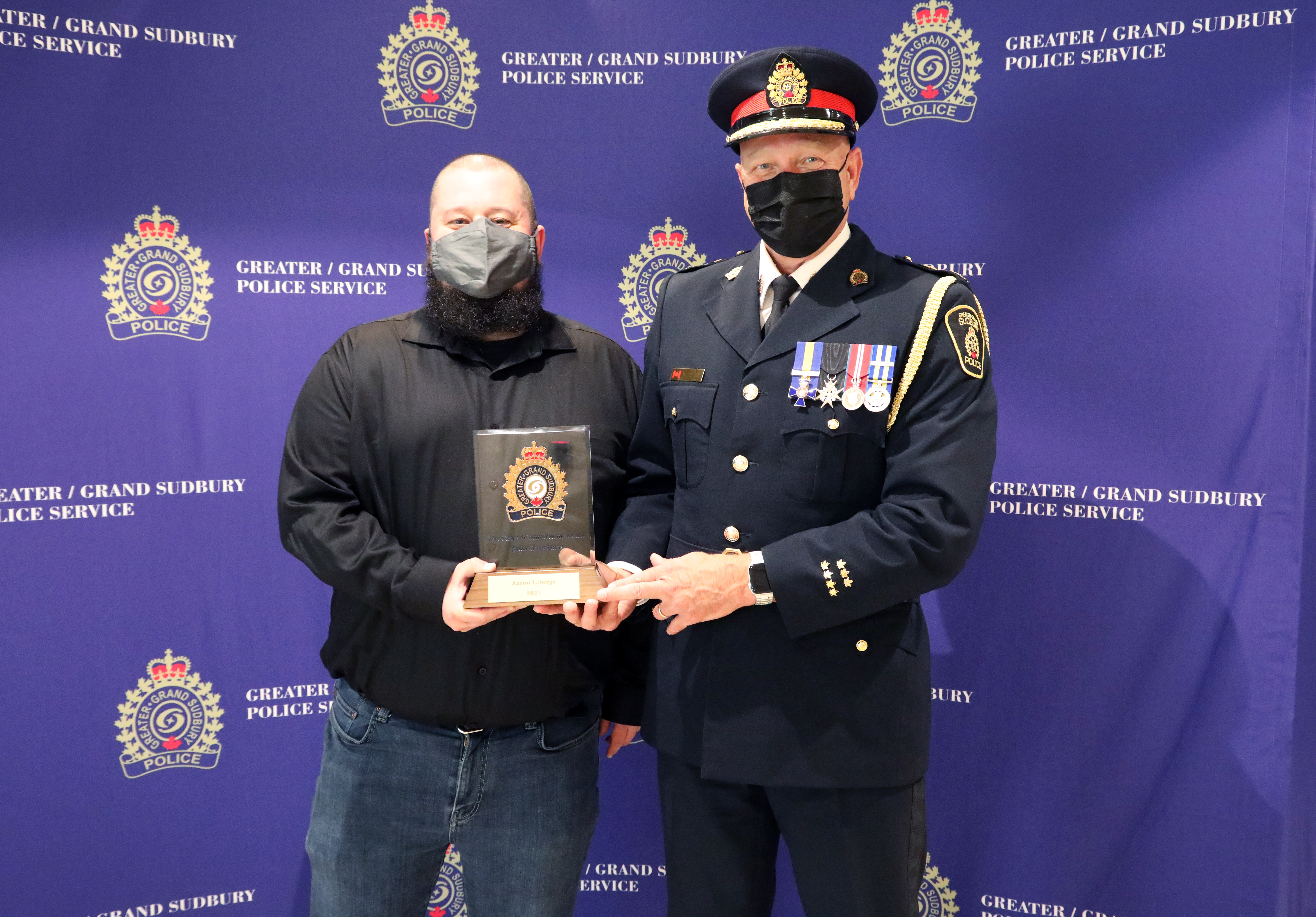man standing with Chief of Police holding award