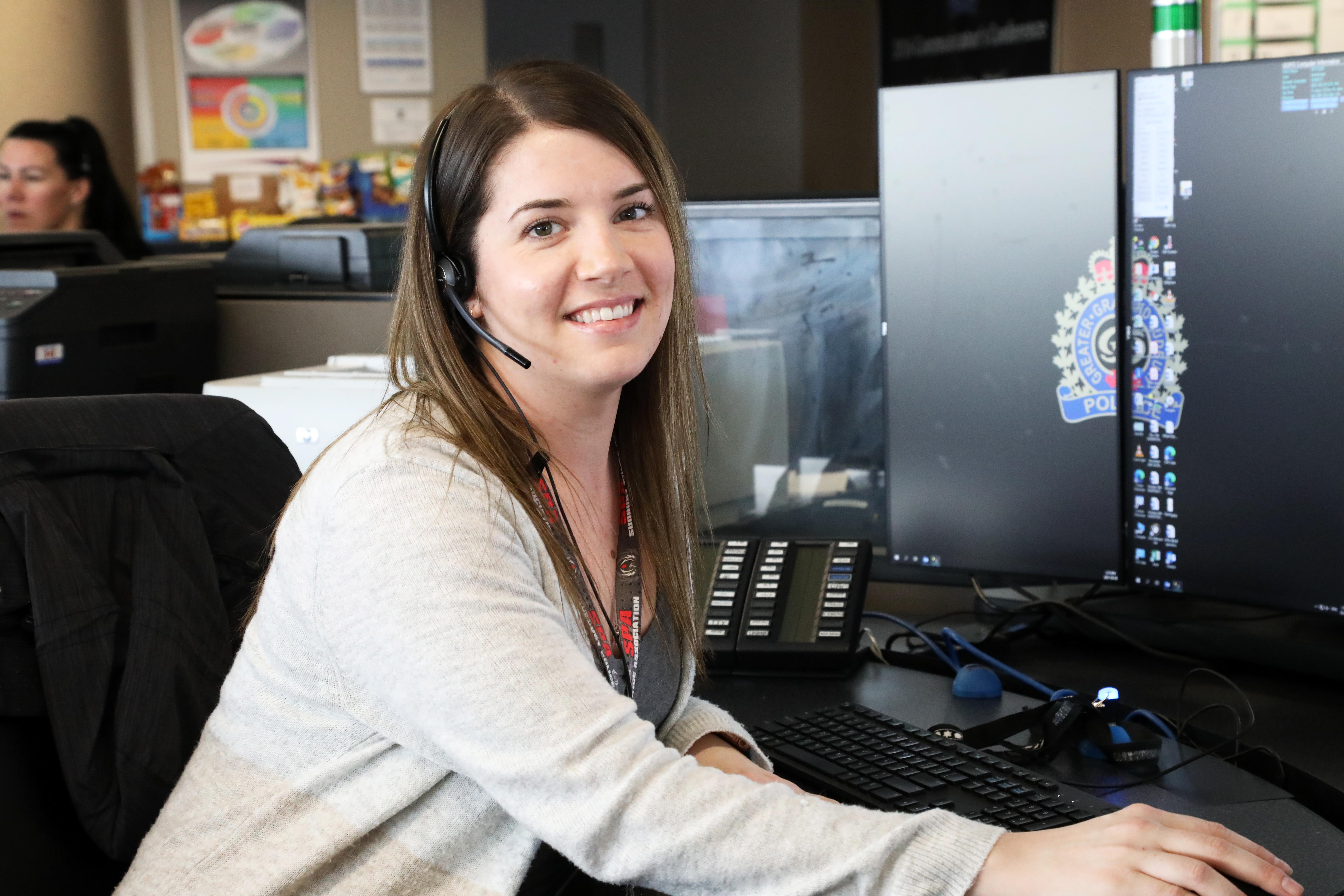 Communicator sitting at desk smiling