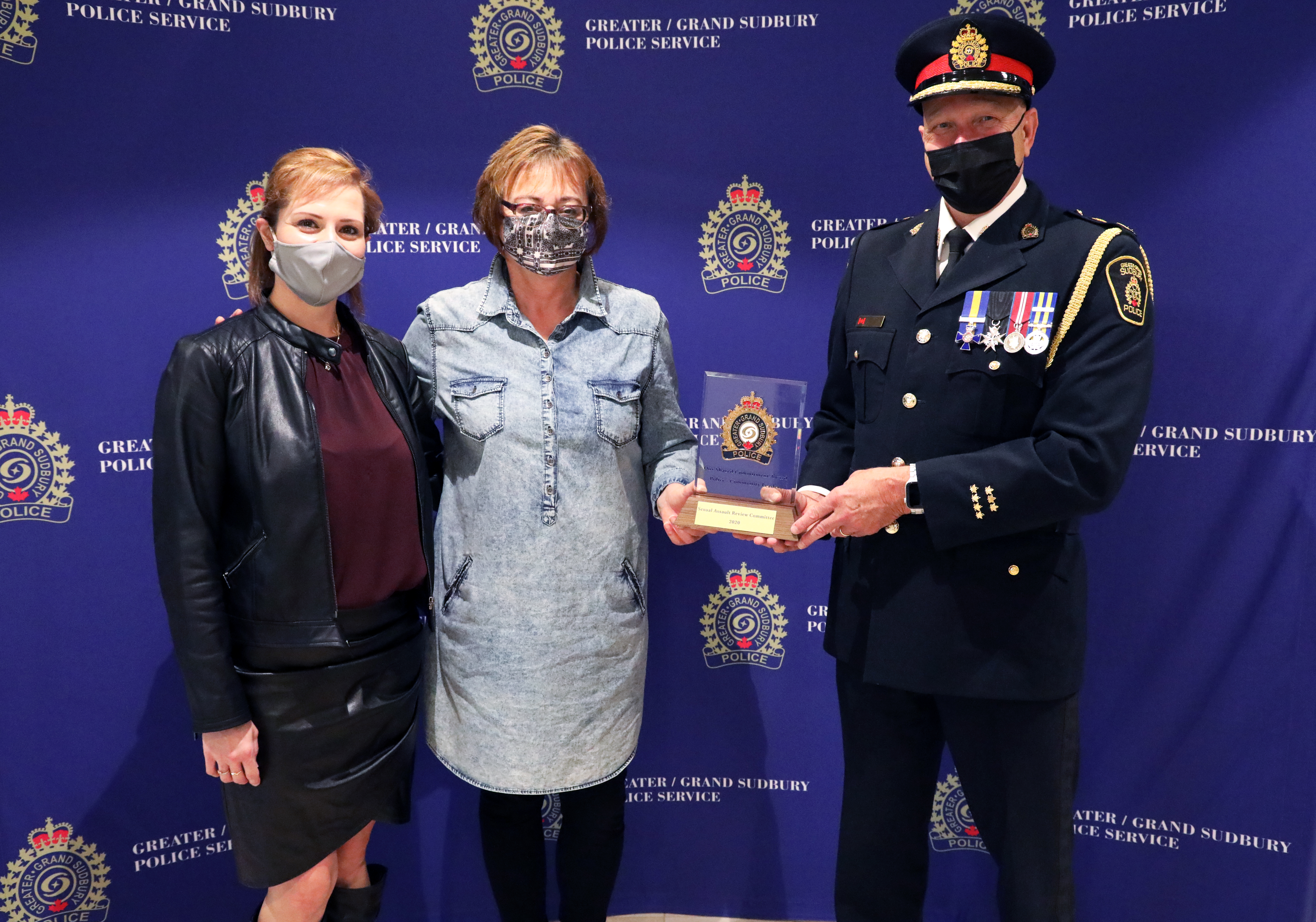 women standing with chief of police