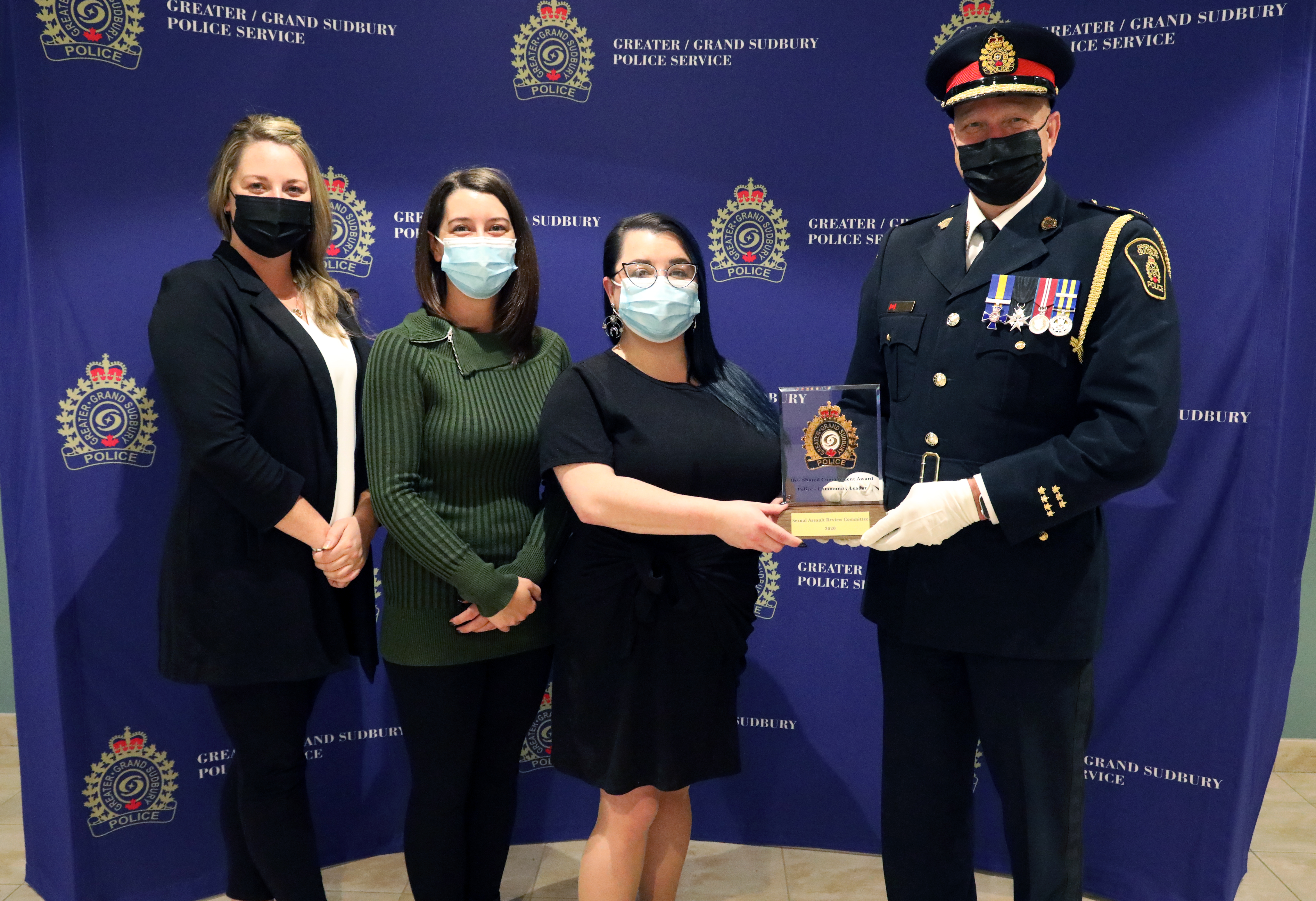 women standing with chief of police