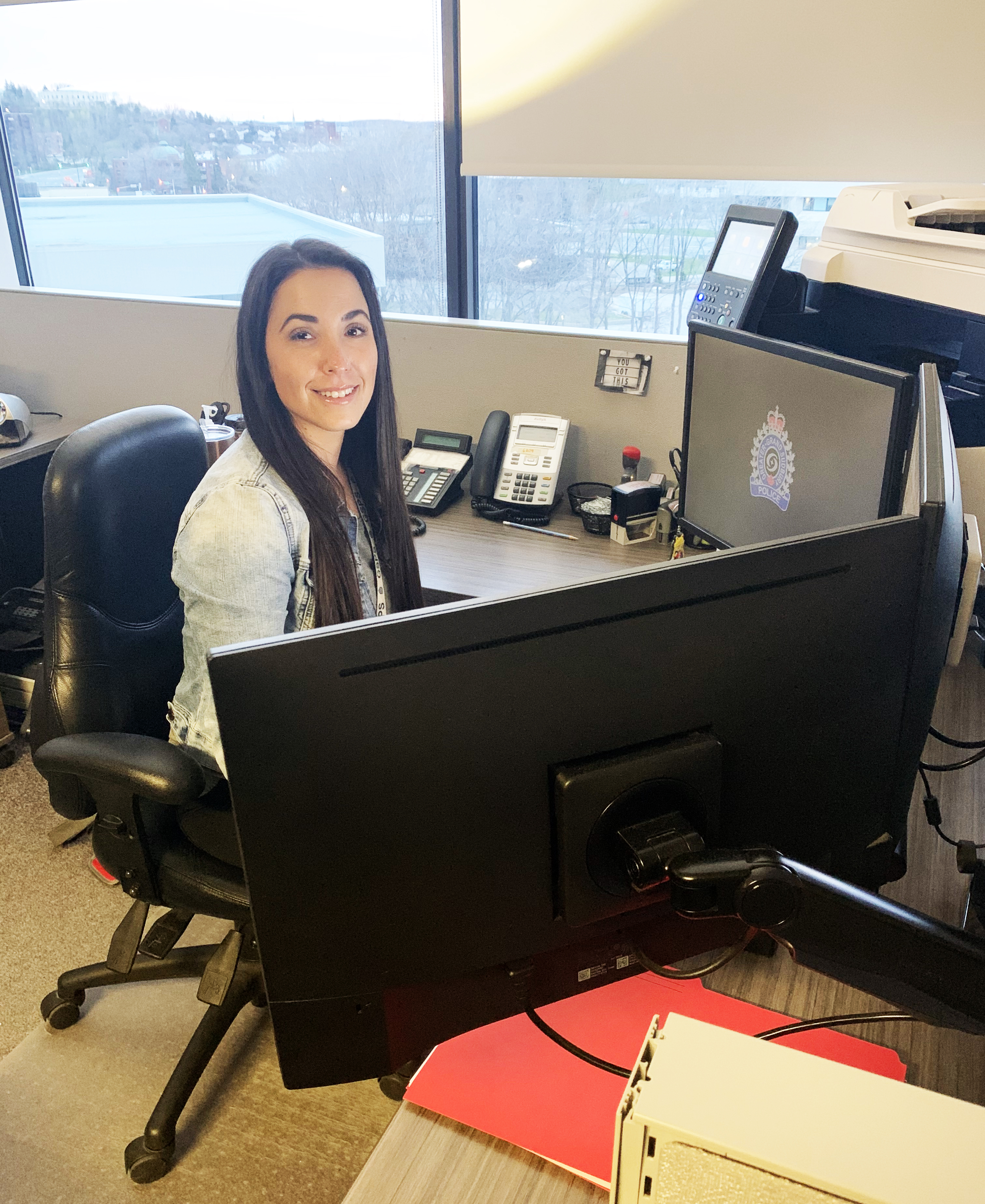 woman sitting at computer desk smiling