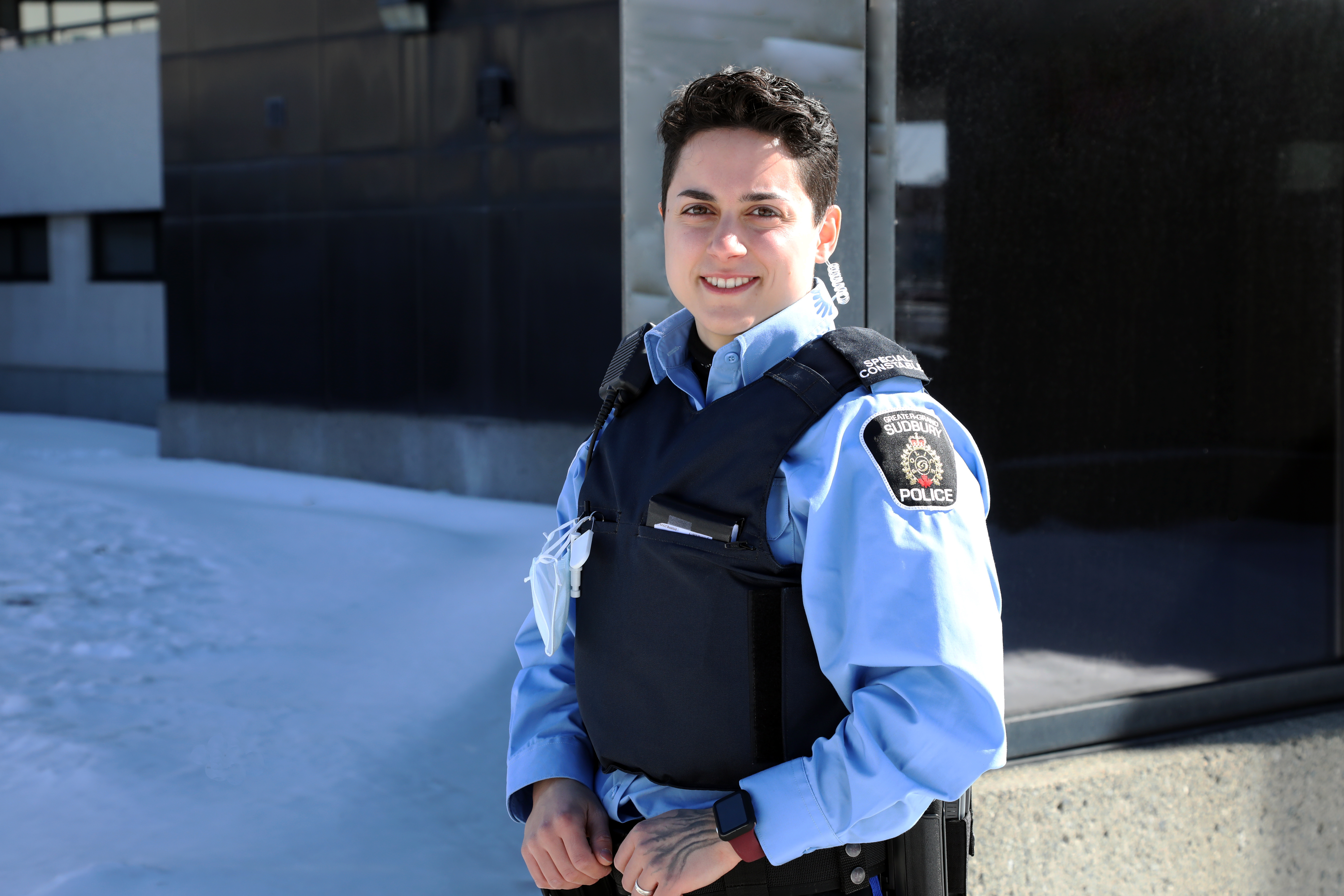 woman in uniform standing outside smiling