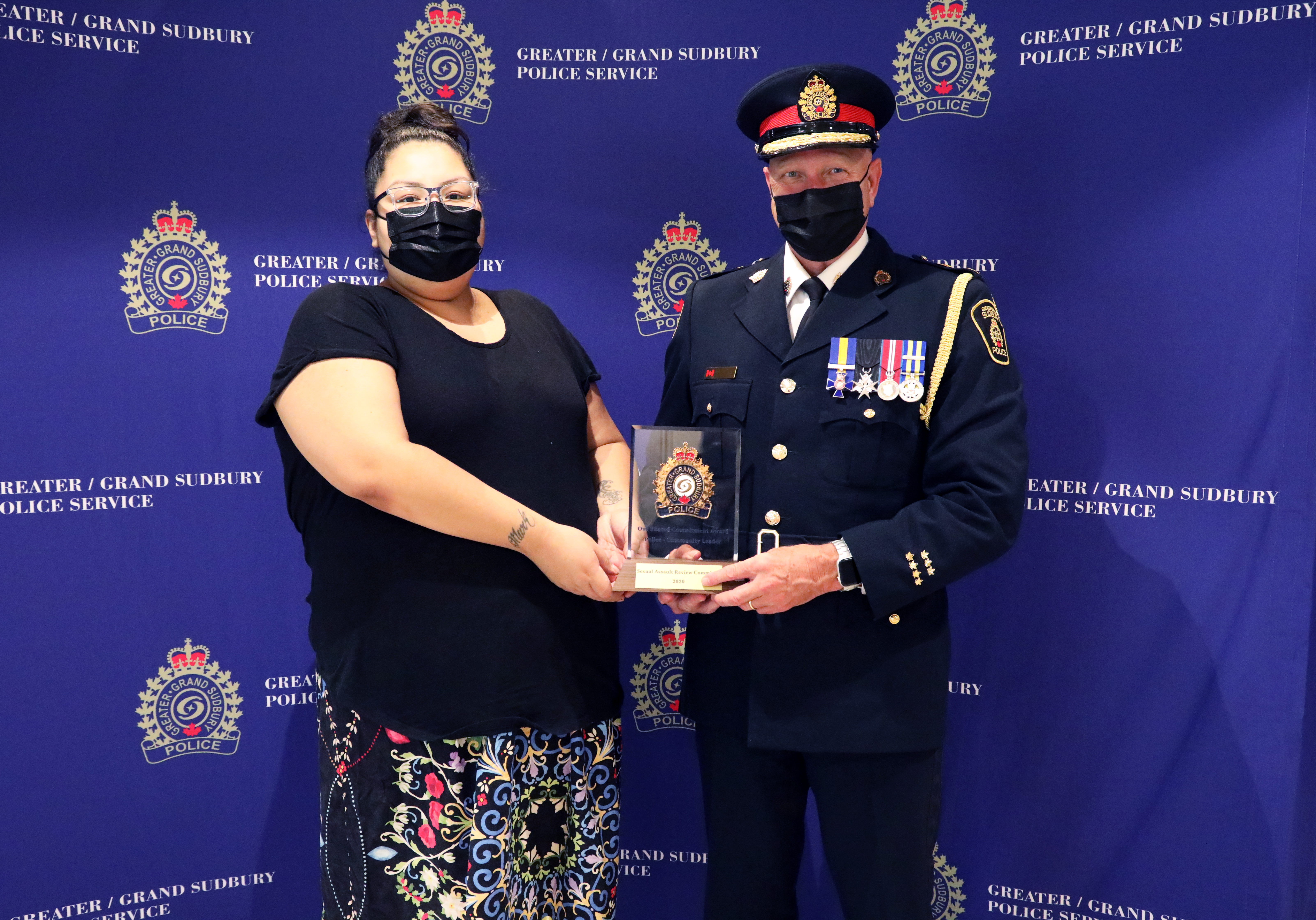 woman standing with chief of police