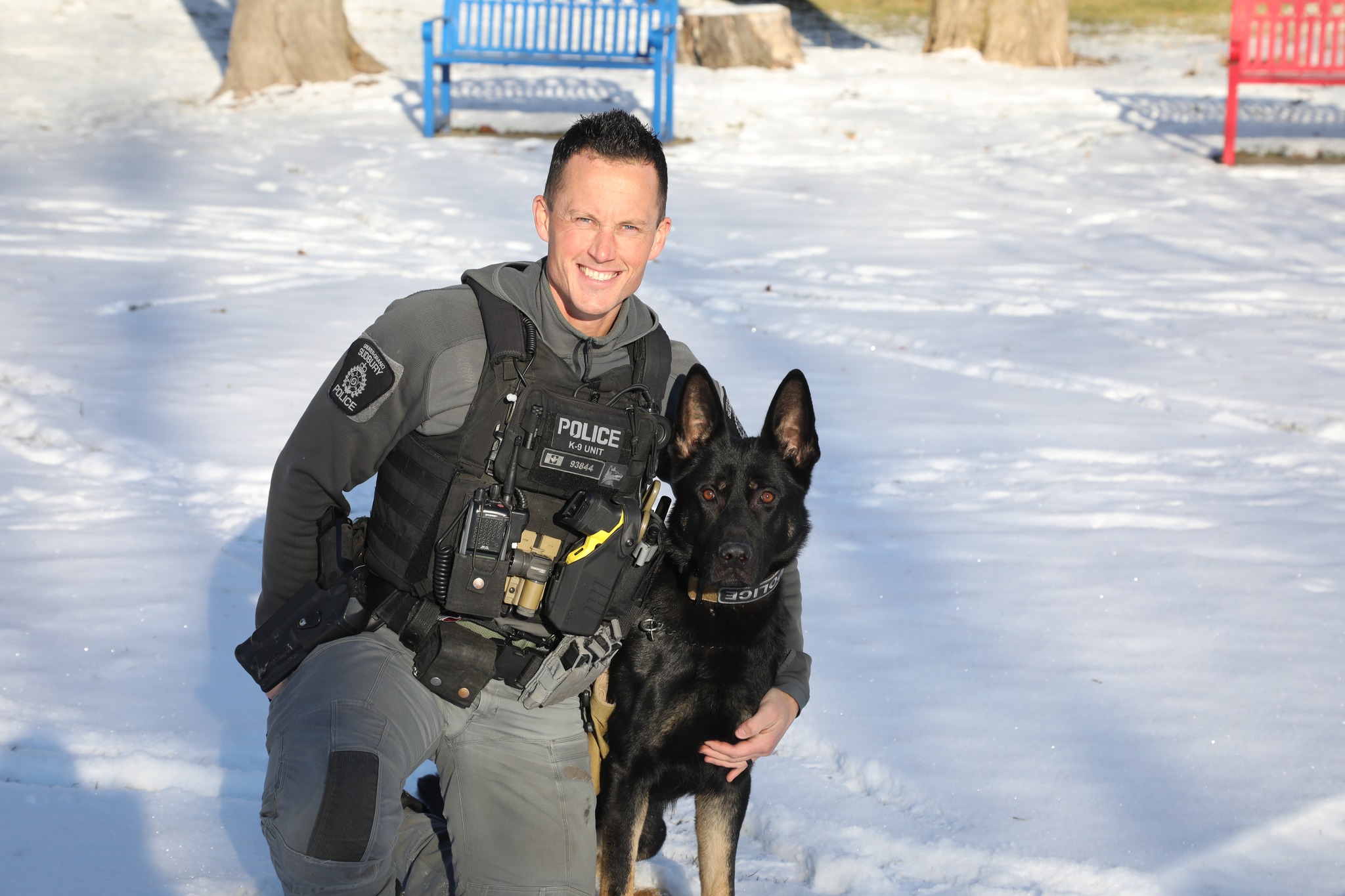 police officer and dog outside in snow