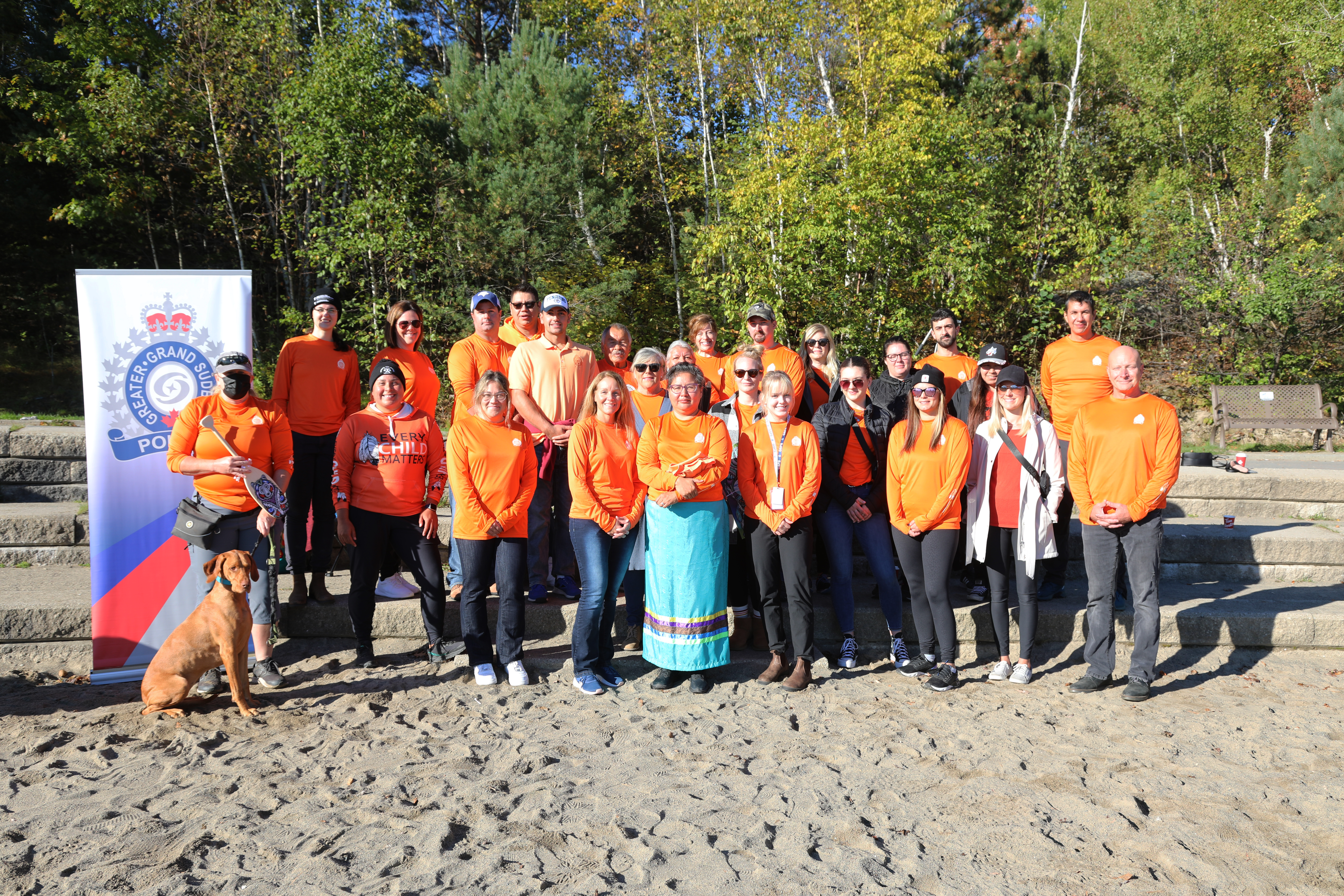 group of people wearing orange shirts