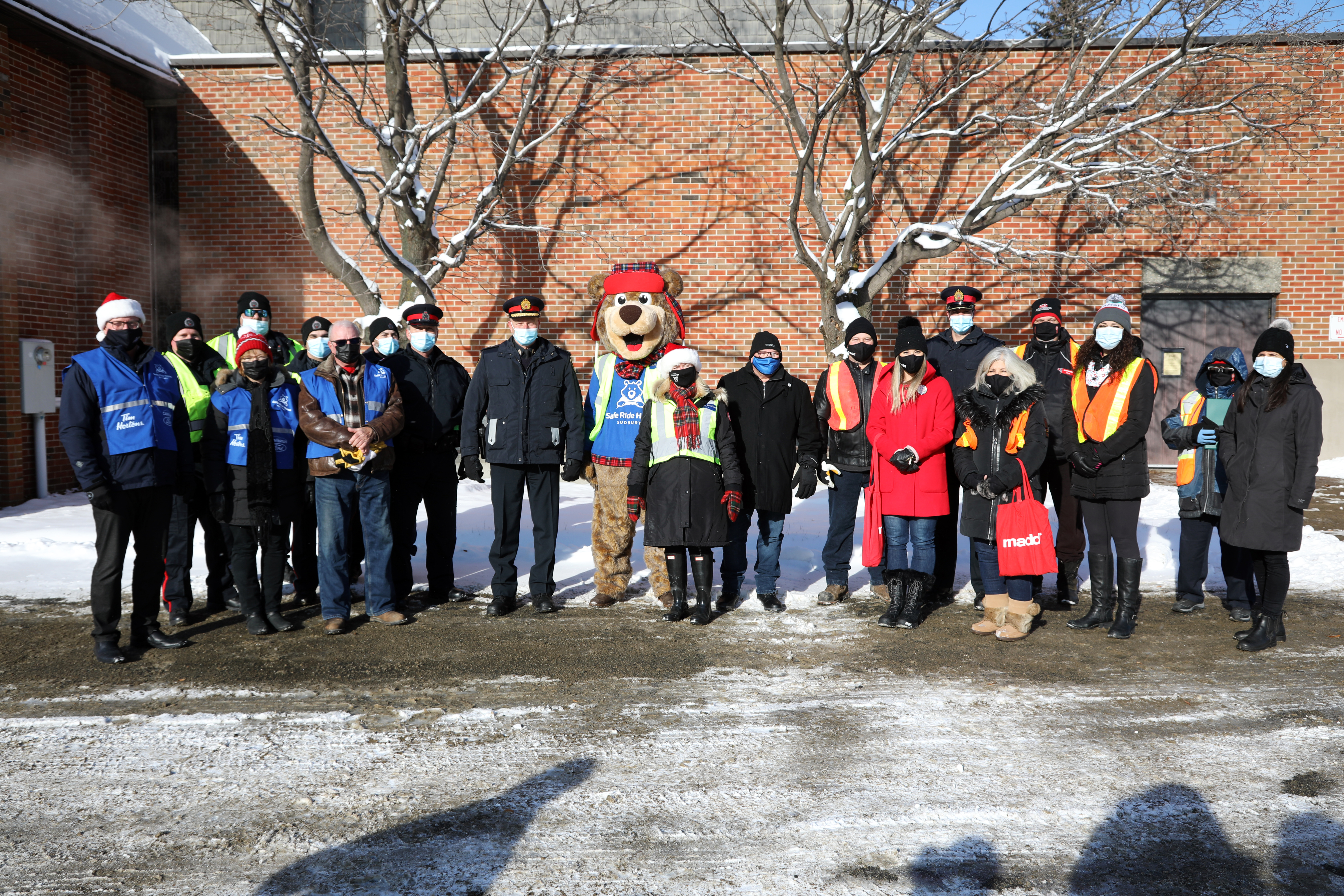 group of people standing together outside in winter