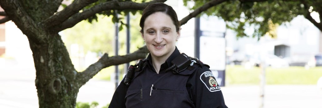 officer standing outside smiling