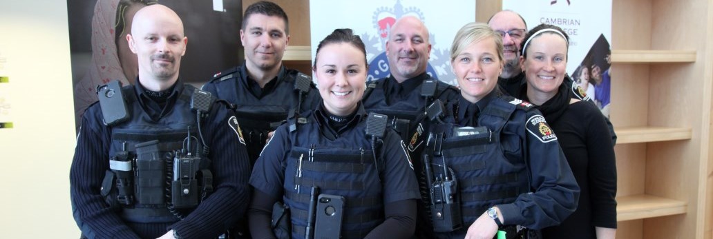 numerous Officers standing and smiling