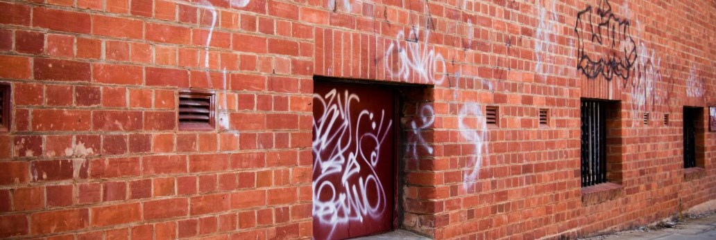 outer brick wall of building with graffiti