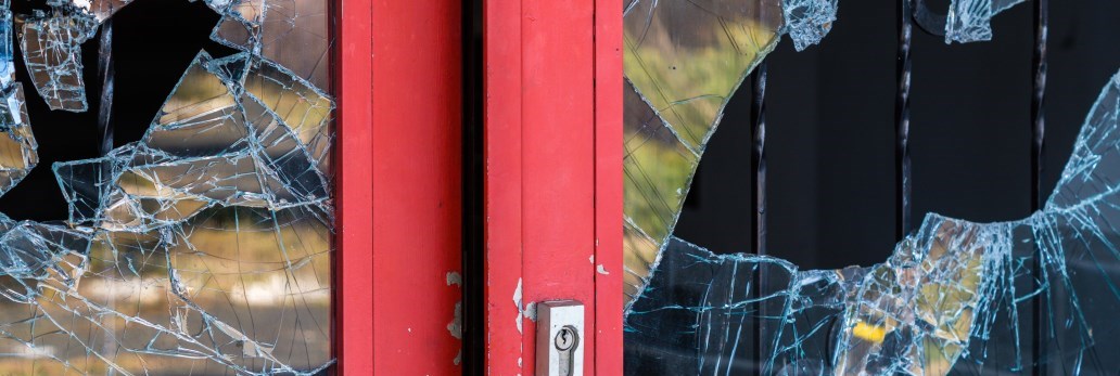 shattered windows on outside door of building