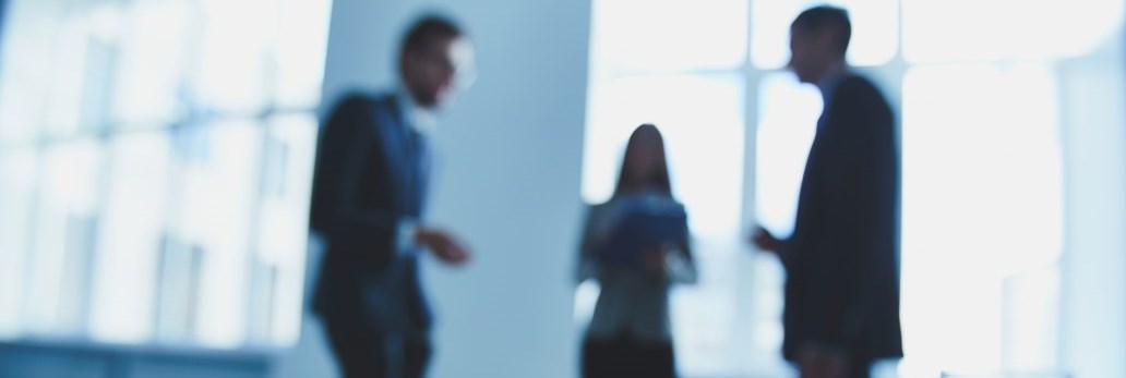 three blurred professionals having discussion