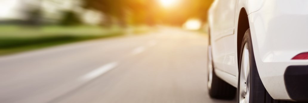 car speeding on sunny road