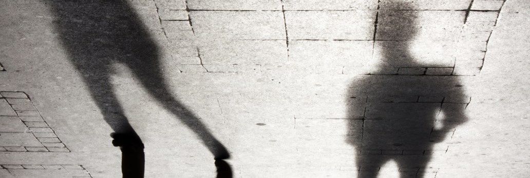 shadows of two people standing side by side