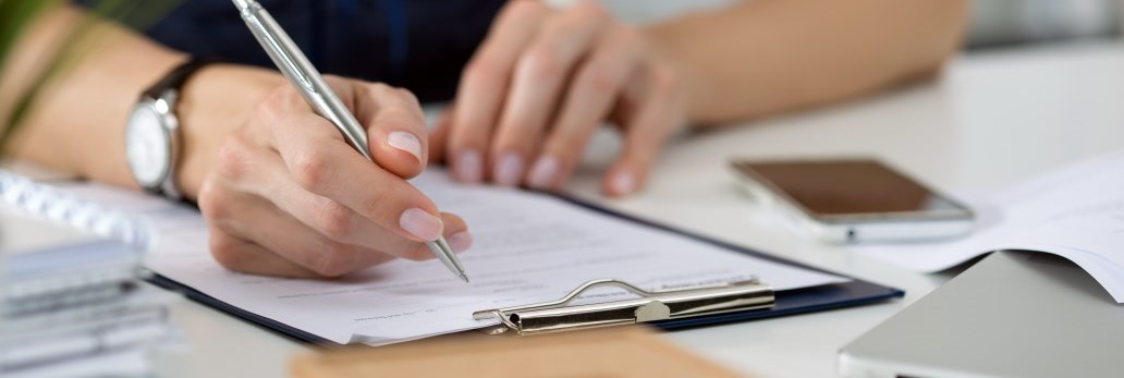 person writing on document