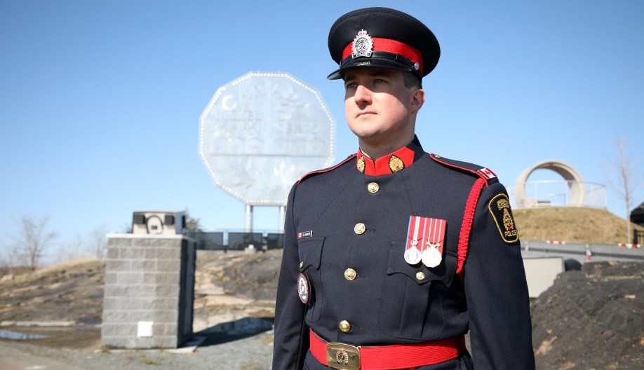 police officer standing in front of Big Nickel