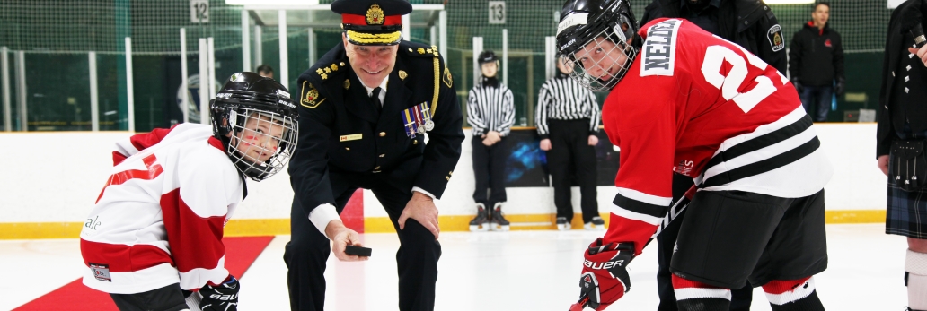 The police chief dropping a puck for kids
